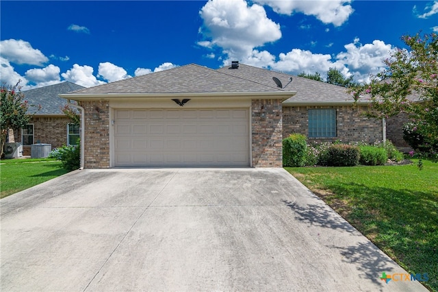 single story home with central air condition unit, a garage, and a front lawn