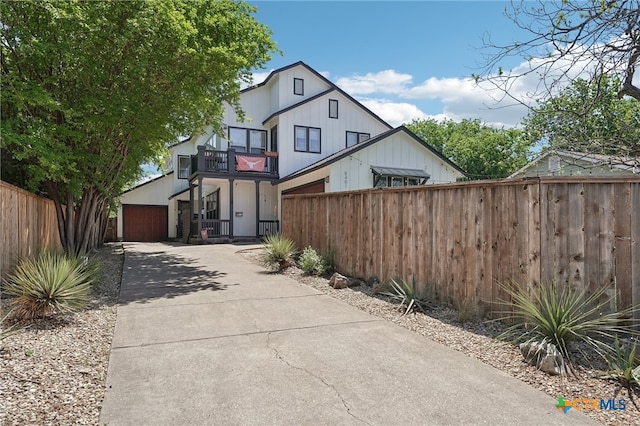 5401 Joe Sayers Ave Unit B, Austin, TX 78756 - view of front of home featuring a fenced front yard, a garage, a balcony, and concrete driveway