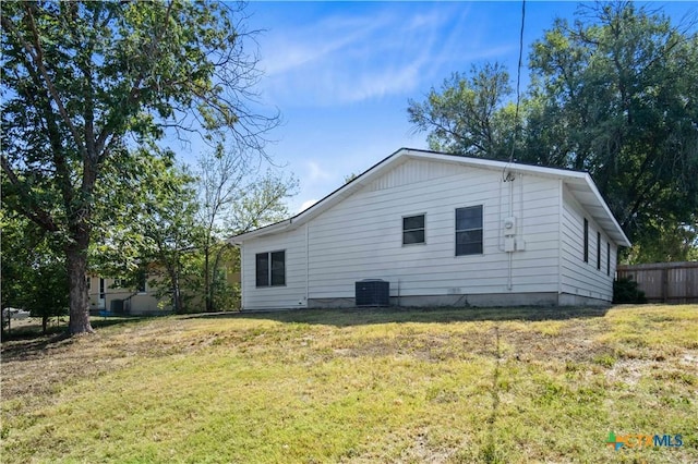 view of home's exterior with a yard and cooling unit