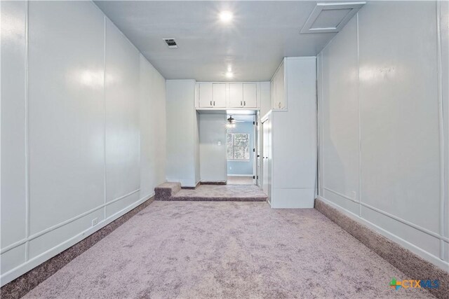 unfurnished room featuring light colored carpet