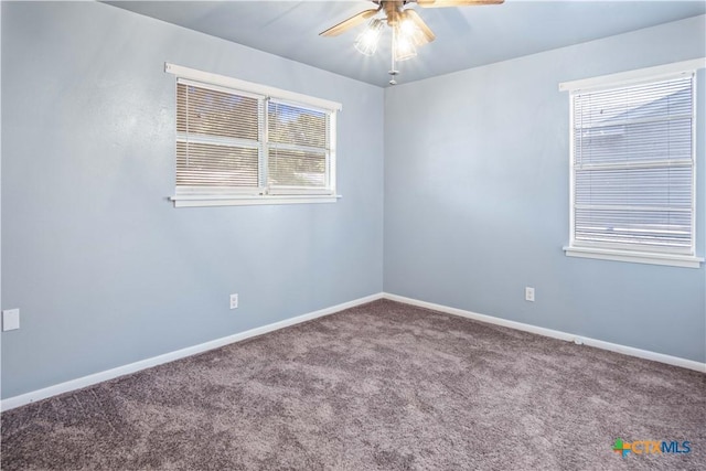 unfurnished room with ceiling fan and carpet