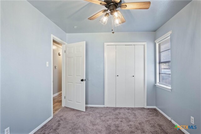 unfurnished bedroom with light carpet, ceiling fan, and a closet