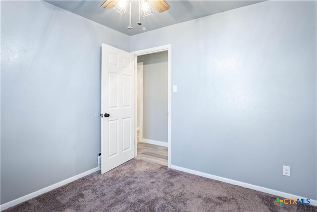 empty room featuring carpet flooring and ceiling fan