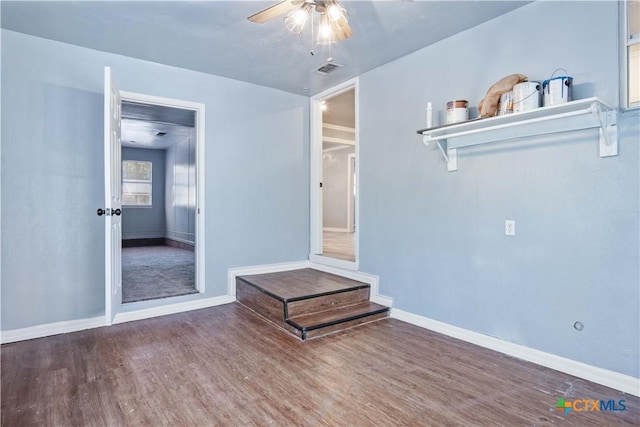 unfurnished living room featuring ceiling fan and hardwood / wood-style floors