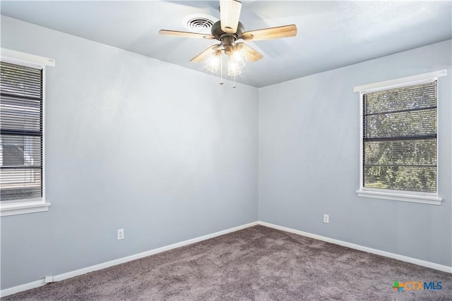 empty room with ceiling fan and carpet