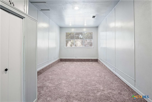 spare room featuring light carpet