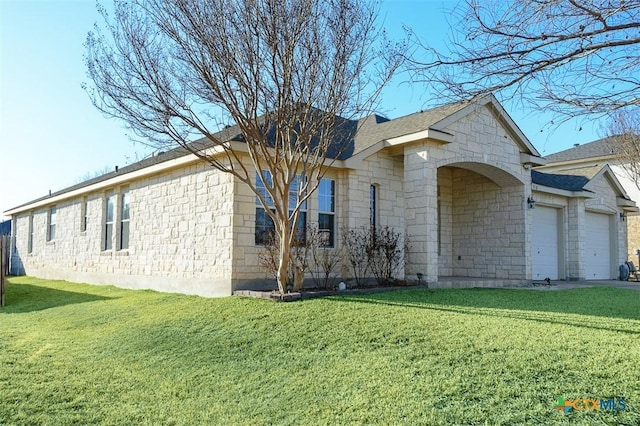 view of front of house with a garage, stone siding, and a front lawn