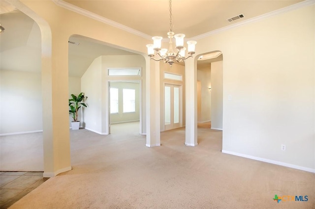 unfurnished dining area with carpet, visible vents, arched walkways, and crown molding