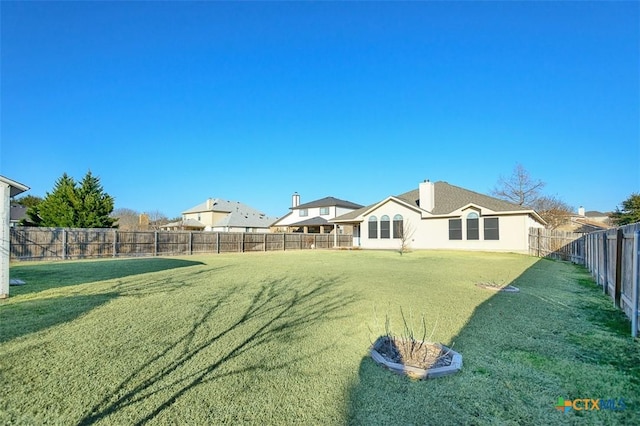 view of yard with a fenced backyard