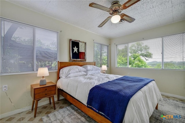 284 Lake Frst, Canyon Lake, TX 78133 - bedroom featuring baseboards and a ceiling fan