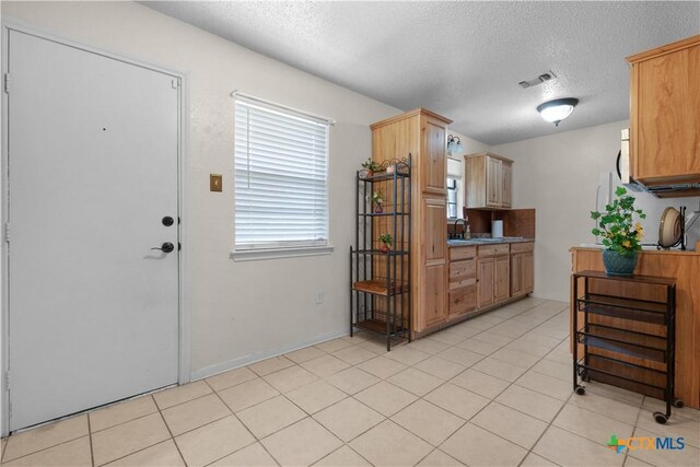 502 Geri Dr, Copperas Cove, TX 76522 - kitchen with a textured ceiling and light tile patterned floors