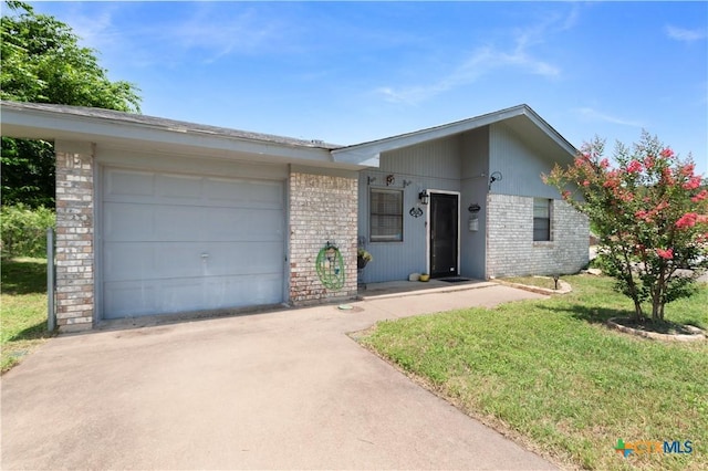 502 Geri Dr, Copperas Cove, TX 76522 - view of front of house with brick siding, concrete driveway, a garage, and a front lawn