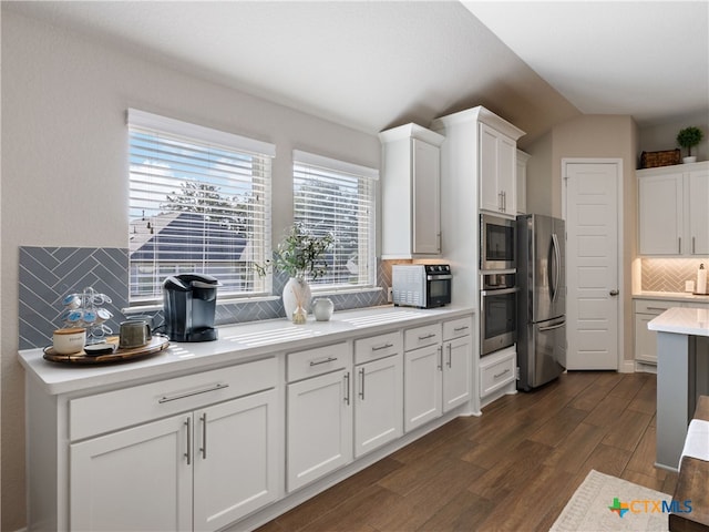 514 Orchard Way, New Braunfels, TX 78132 - kitchen with stainless steel appliances, backsplash, light countertops, white cabinetry, and vaulted ceiling