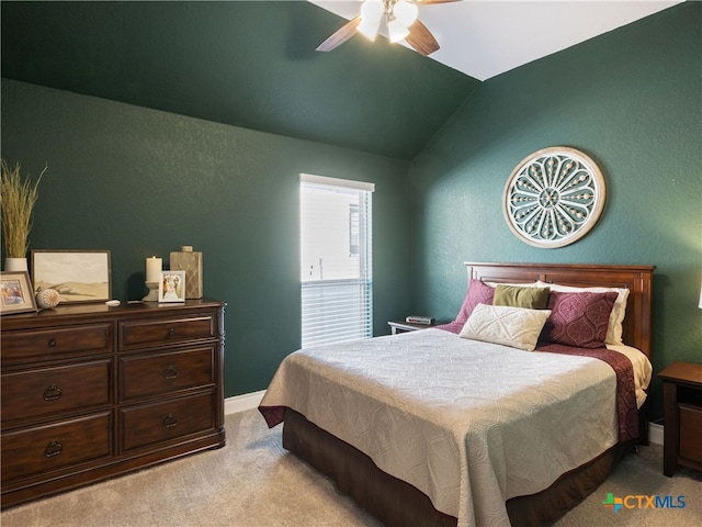 bedroom featuring light colored carpet, vaulted ceiling, and ceiling fan