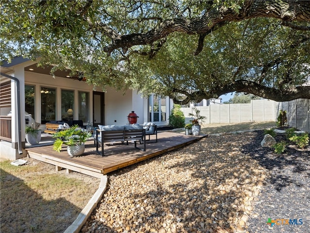 back of property featuring an outdoor living space and a wooden deck