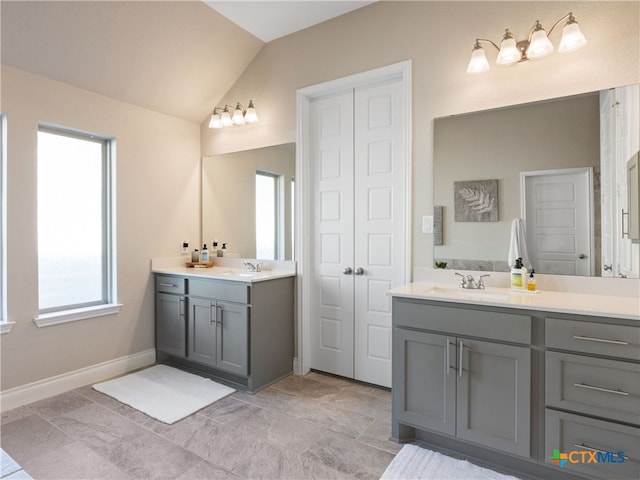 bathroom with vanity and vaulted ceiling