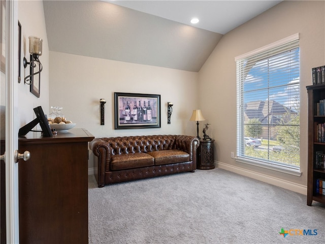 carpeted living room with lofted ceiling