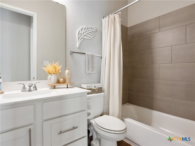 full bathroom featuring vanity, shower / bath combo, and toilet