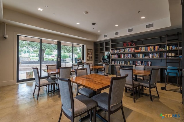 dining area featuring finished concrete floors and visible vents