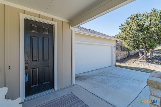 view of exterior entry featuring a garage