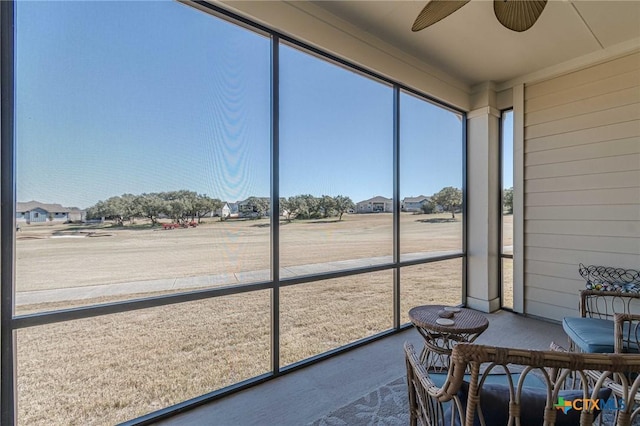 sunroom with a ceiling fan