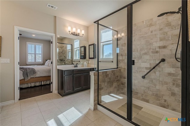 bathroom with tile patterned flooring, vanity, and a shower with door