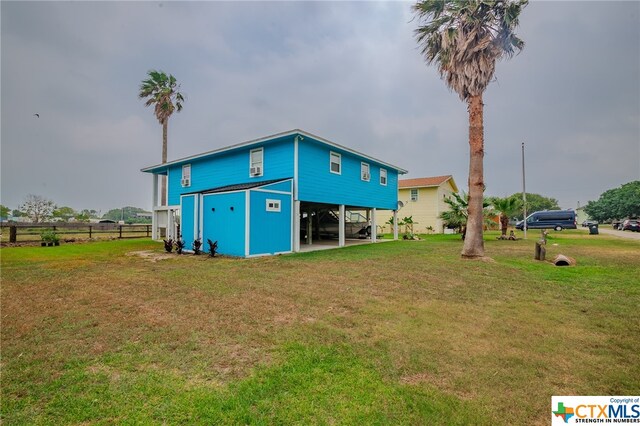 exterior space with a carport, driveway, and fence