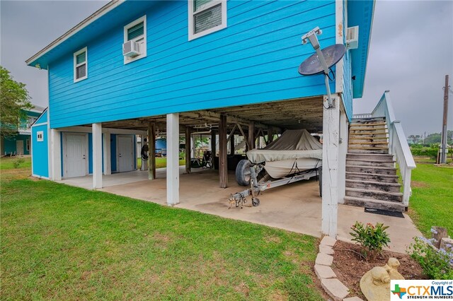 exterior space featuring a carport, stairway, a patio, and a yard