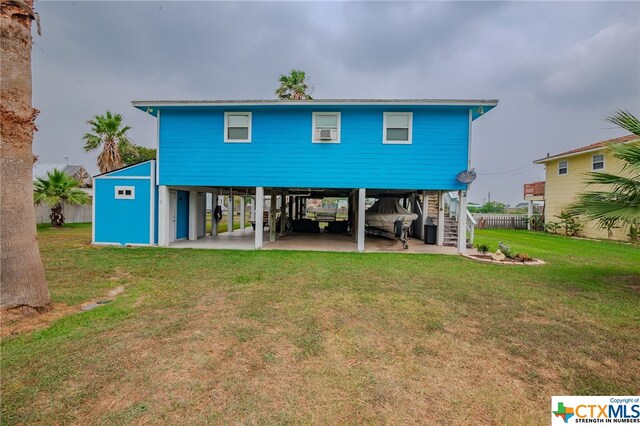 rear view of house with a yard and a carport