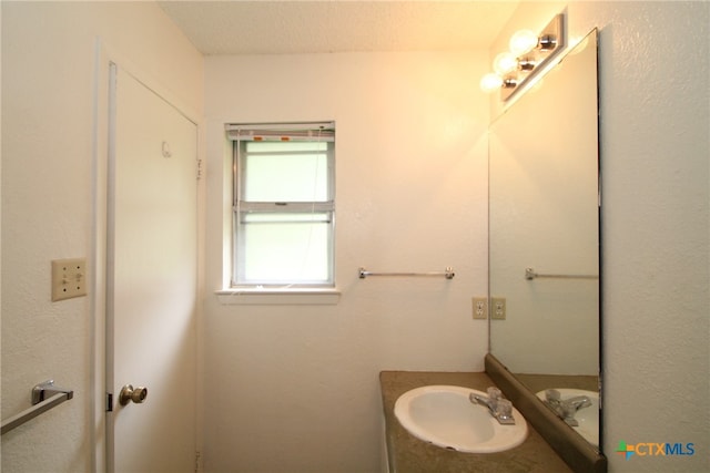 bathroom with vanity and a textured ceiling