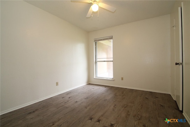 empty room featuring ceiling fan, dark hardwood / wood-style flooring, and vaulted ceiling