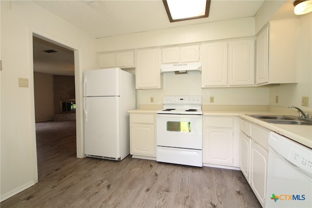 kitchen featuring light wood-type flooring, white appliances, and white cabinetry