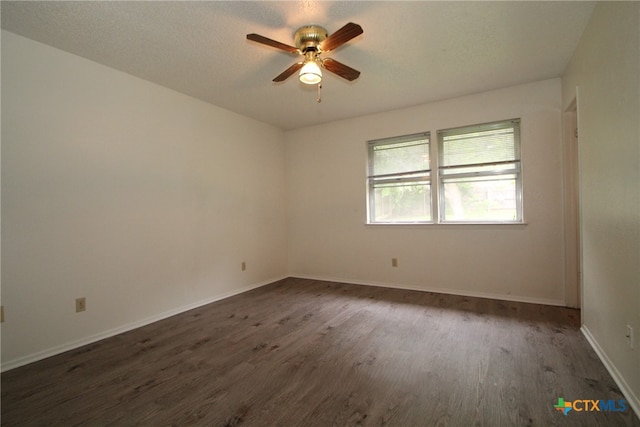 unfurnished room featuring ceiling fan, dark hardwood / wood-style flooring, and a textured ceiling