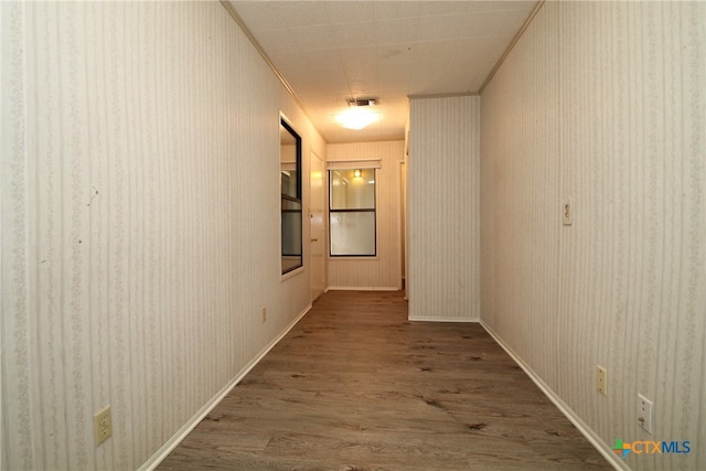 hallway featuring hardwood / wood-style flooring and ornamental molding