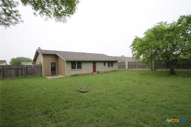 back of house with a lawn