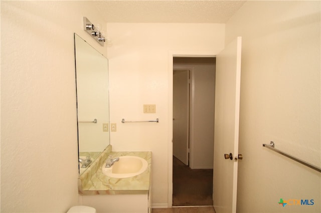 bathroom with vanity and a textured ceiling