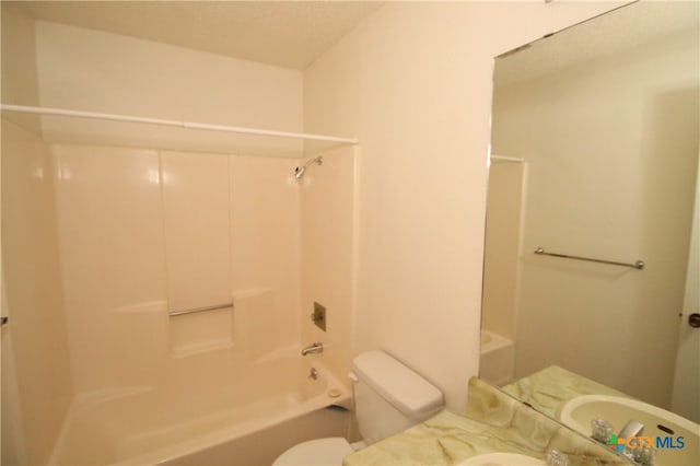 full bathroom featuring vanity, bathtub / shower combination, and toilet