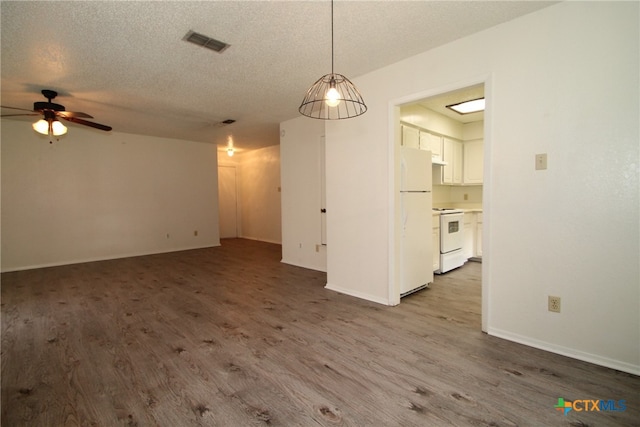 unfurnished living room featuring ceiling fan, light wood-type flooring, and a textured ceiling