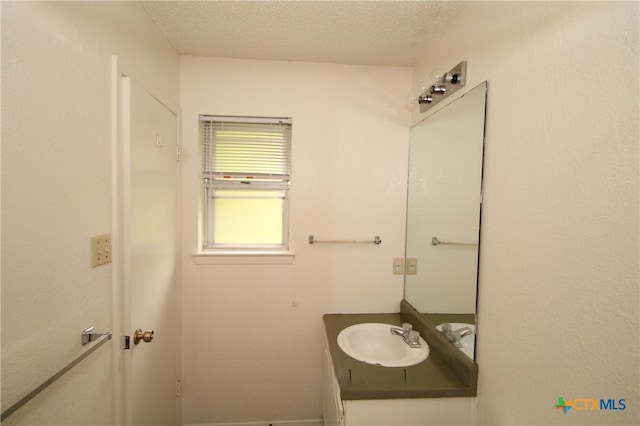 bathroom featuring vanity and a textured ceiling