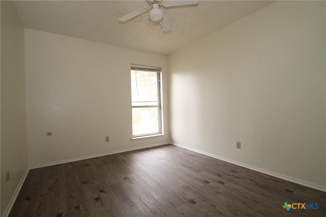 spare room featuring a textured ceiling, ceiling fan, and dark wood-type flooring