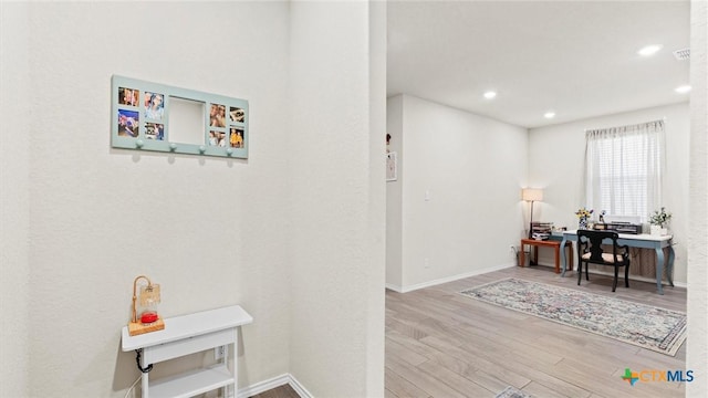 hallway with hardwood / wood-style flooring