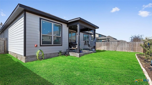 rear view of house featuring a yard