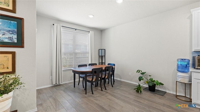 dining area featuring light wood-type flooring