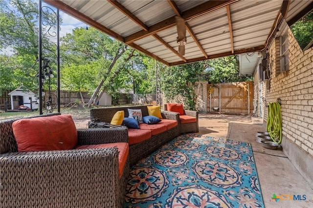 view of patio with an outdoor structure, outdoor lounge area, and a fenced backyard