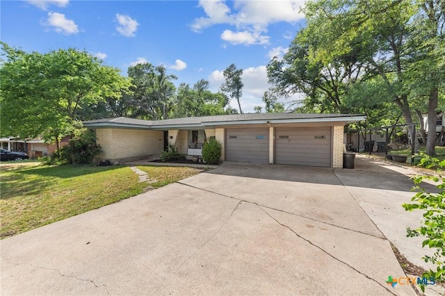 ranch-style house with brick siding, a front lawn, concrete driveway, and an attached garage