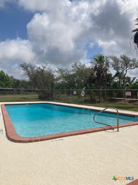 144 Sherwood Dr, Rockport, TX 78382 - pool with a patio area and fence