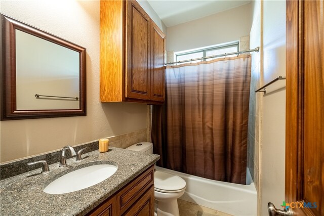 full bathroom featuring toilet, vanity, and shower / bath combination with curtain