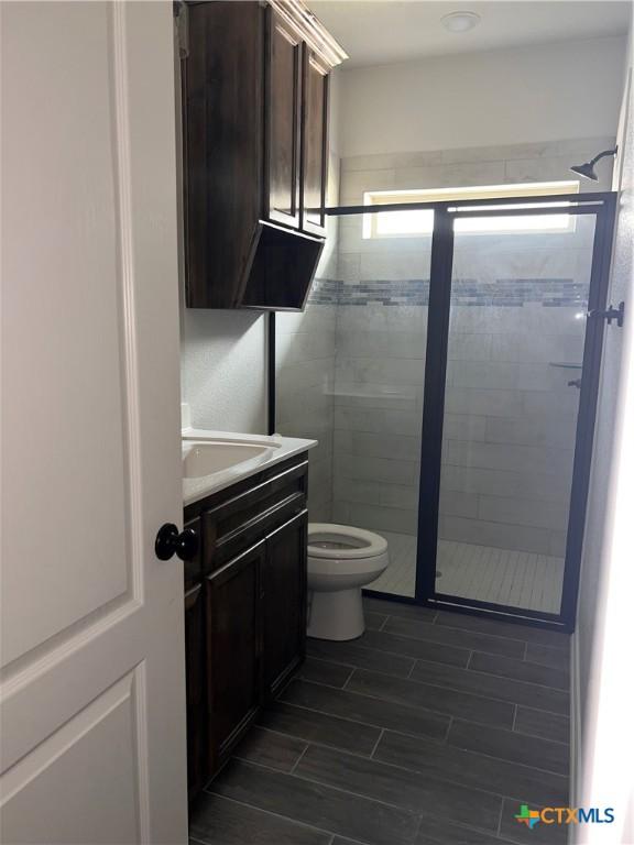 806 Dred Roger Cir, Killeen, TX 76542 - bathroom featuring vanity, a stall shower, and wood tiled floors