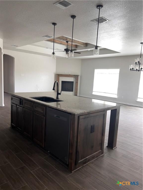 806 Dred Roger Cir, Killeen, TX 76542 - kitchen with dishwasher, open floor plan, dark wood-style floors, a textured ceiling, and an island with sink
