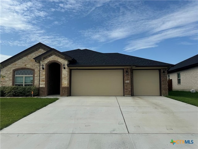 806 Dred Roger Cir, Killeen, TX 76542 - view of front facade with an attached garage, concrete driveway, brick siding, and a front yard